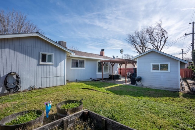 back of house featuring a patio, fence, a yard, a vegetable garden, and a pergola