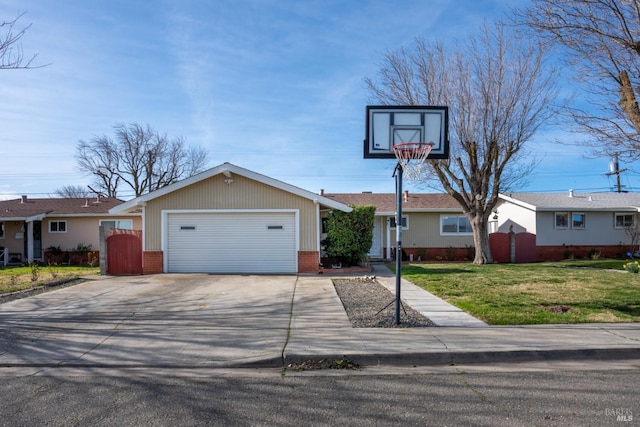 view of front of house with a front yard, fence, driveway, a garage, and brick siding