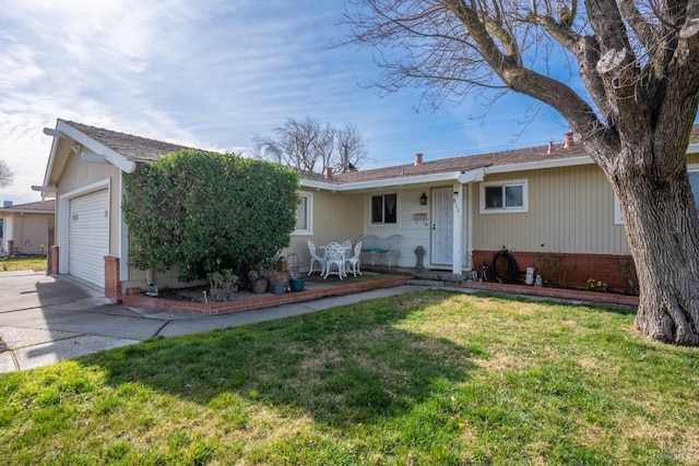 ranch-style house featuring a front yard, concrete driveway, and brick siding