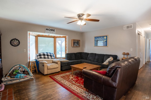 living room with ceiling fan, wood finished floors, and visible vents