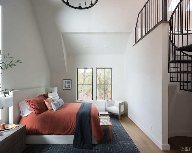 bedroom featuring wood finished floors and baseboards