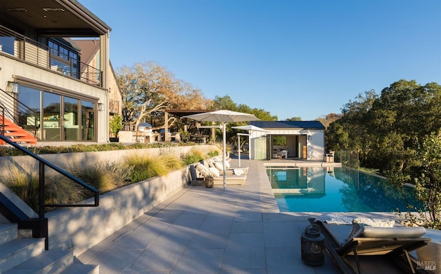 outdoor pool featuring an exterior structure, stairs, a patio, and an outdoor structure