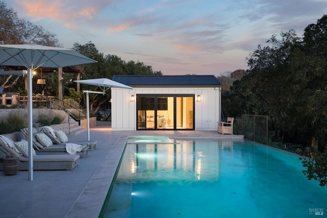 view of pool with a patio area, an outbuilding, a fenced in pool, and an exterior structure