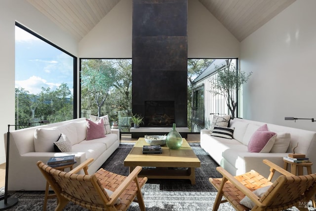 sunroom featuring lofted ceiling and a fireplace