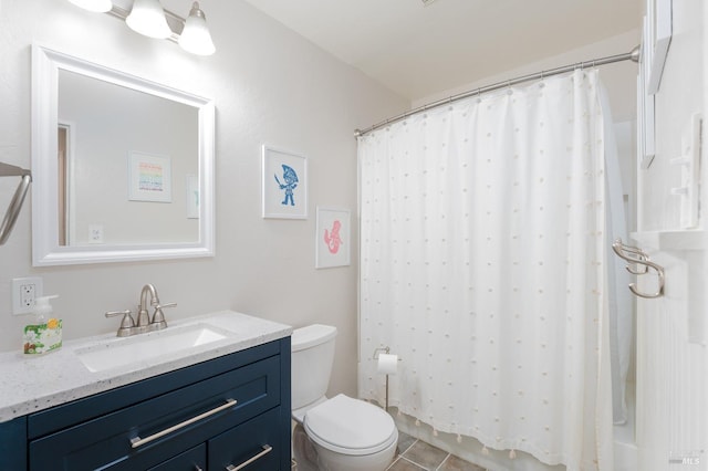 bathroom with toilet, tile patterned floors, and vanity