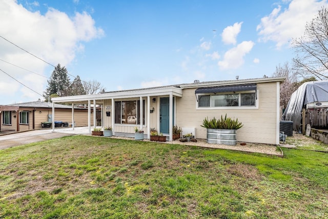 ranch-style house with a carport, driveway, a front lawn, and central AC unit