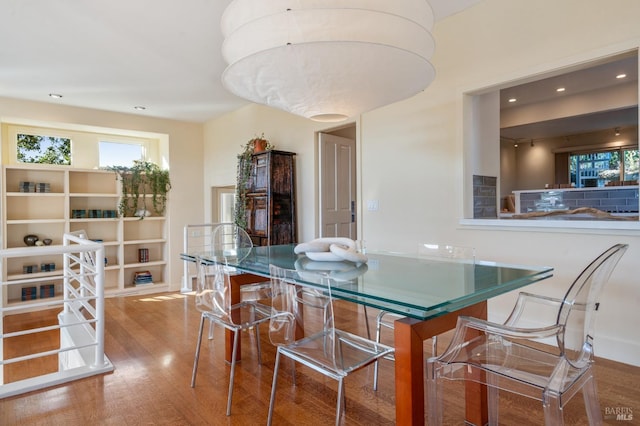 dining space featuring wood finished floors and recessed lighting