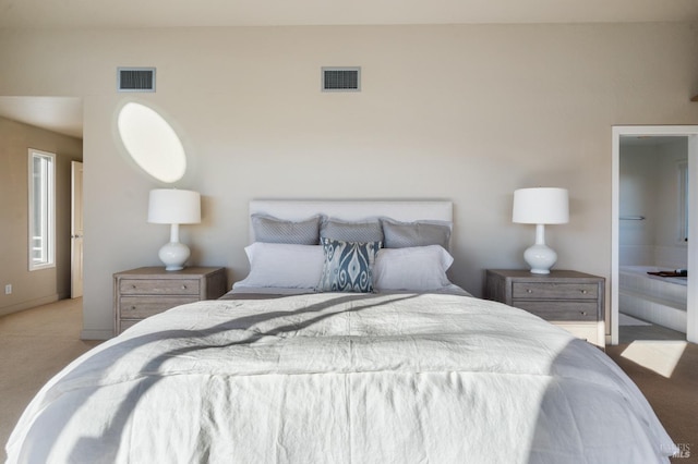 bedroom featuring light colored carpet and visible vents