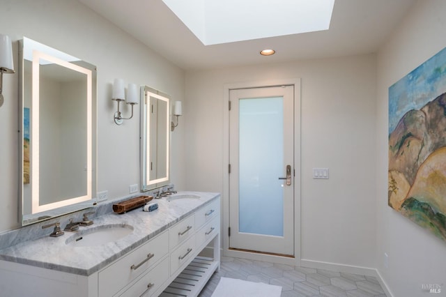 full bath featuring baseboards, double vanity, a sink, and recessed lighting