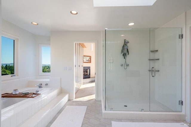 full bath featuring recessed lighting, a garden tub, and a shower stall