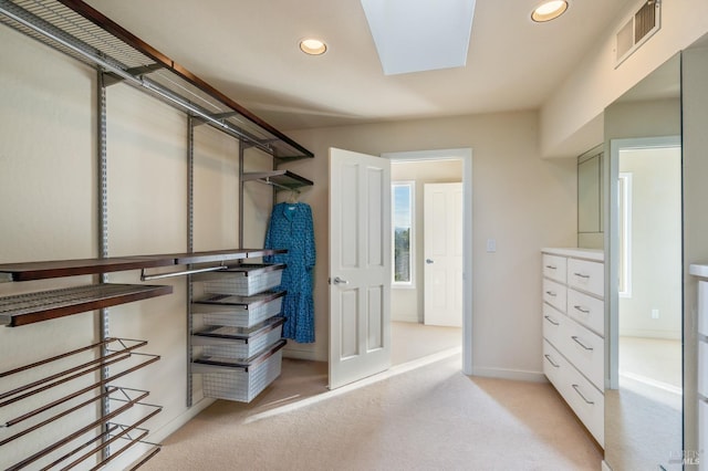 spacious closet featuring visible vents and light colored carpet