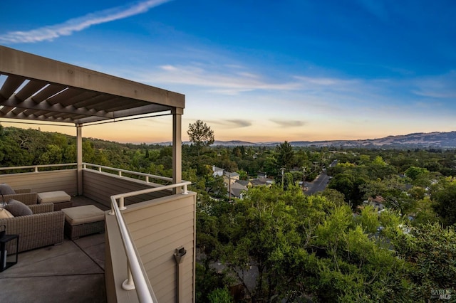 patio terrace at dusk featuring an outdoor hangout area