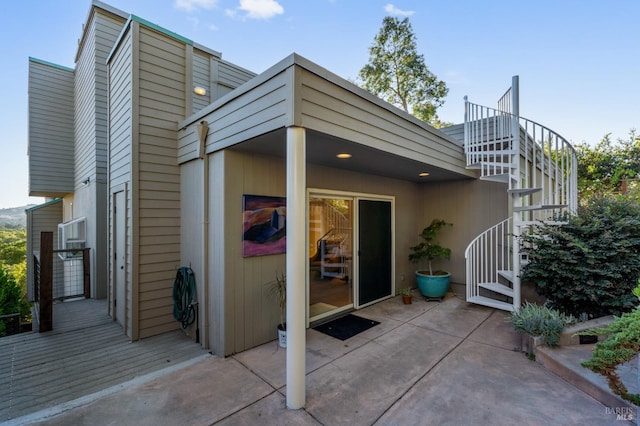 back of property with a patio area and stairs