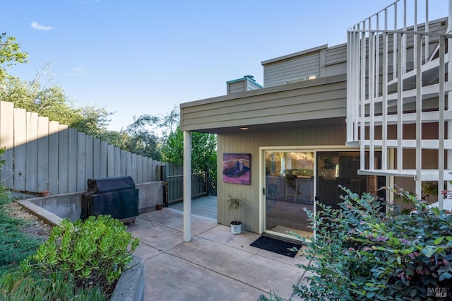 view of patio / terrace featuring fence and a grill