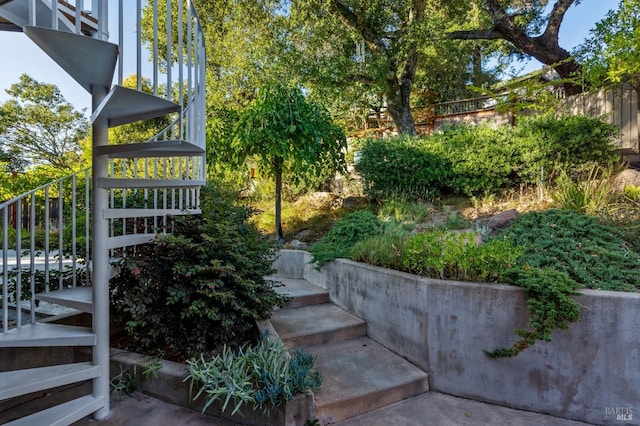 view of yard featuring stairway and fence