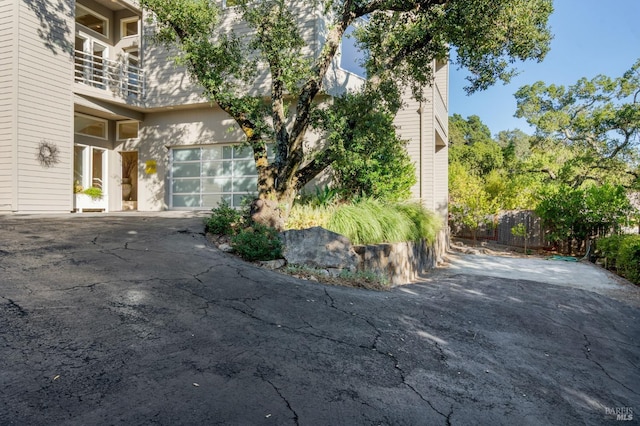 view of property exterior featuring a garage and driveway