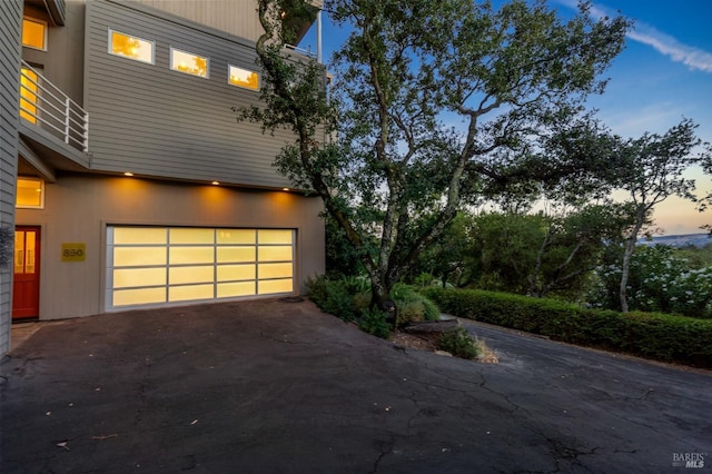 garage at dusk with driveway