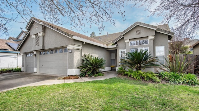 view of front of house with a front lawn, fence, concrete driveway, stucco siding, and a garage