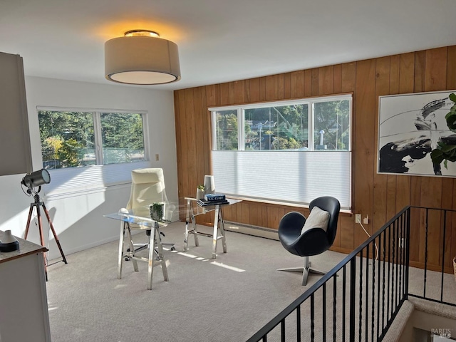 interior space with plenty of natural light, light carpet, and wooden walls