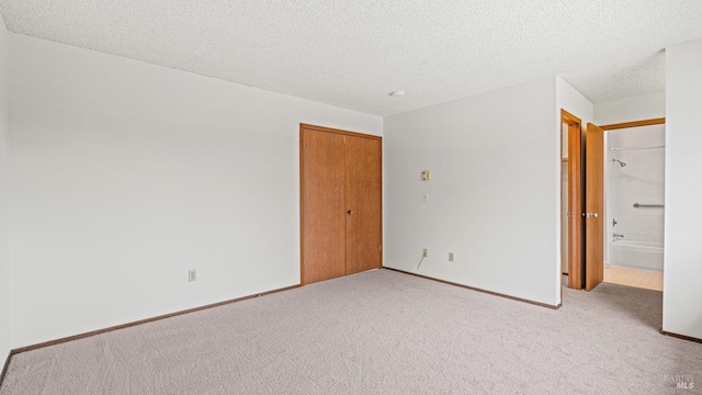 carpeted spare room featuring a textured ceiling