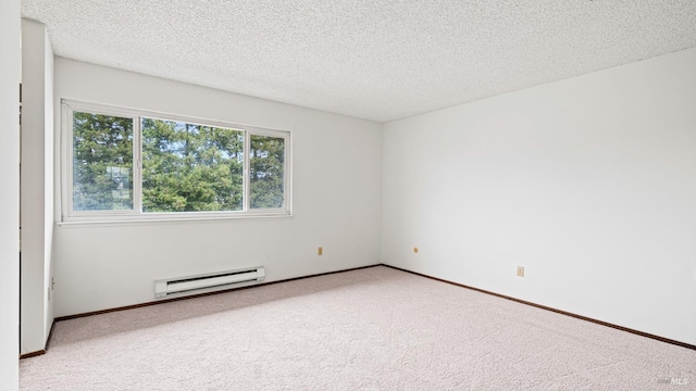 carpeted spare room with a baseboard radiator and a textured ceiling