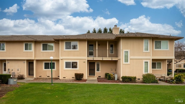 back of house featuring a lawn and central AC unit