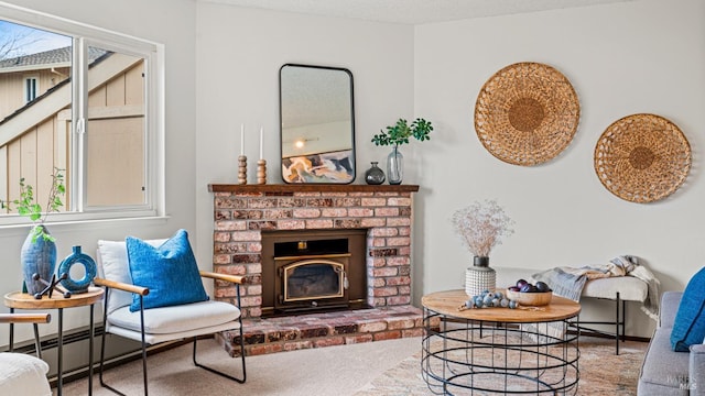 living room with carpet floors, a textured ceiling, and a fireplace