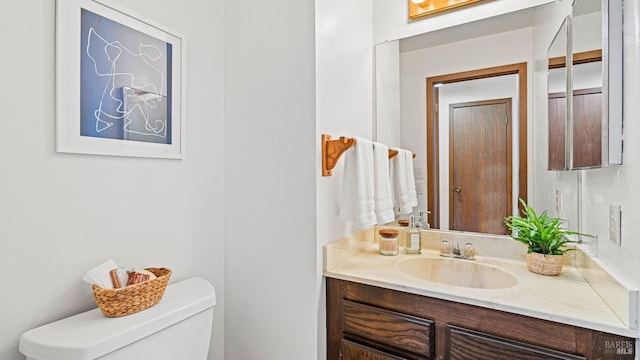 bathroom featuring toilet and vanity