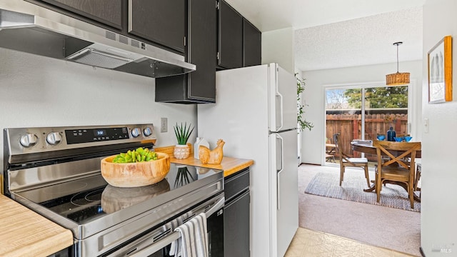 kitchen with white fridge, a textured ceiling, decorative light fixtures, stainless steel electric range, and light colored carpet