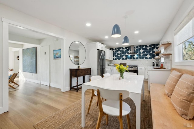 dining area featuring light hardwood / wood-style flooring and sink