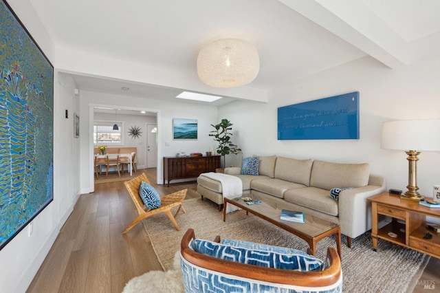 living room with hardwood / wood-style flooring and beam ceiling