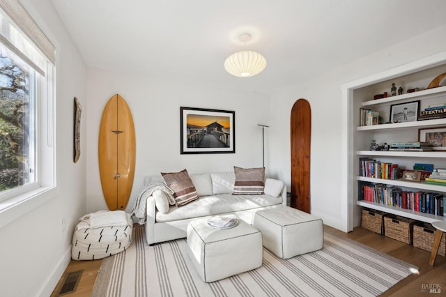 living room featuring a healthy amount of sunlight and hardwood / wood-style flooring