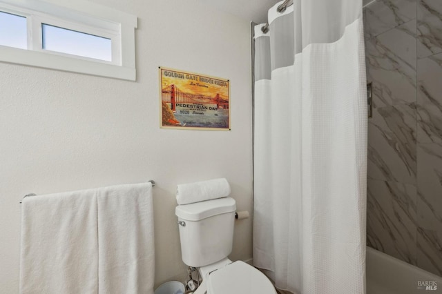 bathroom with shower / tub combo with curtain and toilet