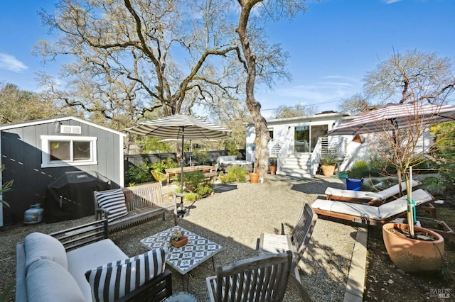 view of patio with outdoor lounge area, an outbuilding, and a grill