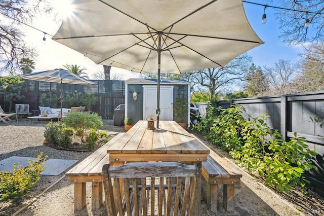 view of patio featuring a shed and a fire pit