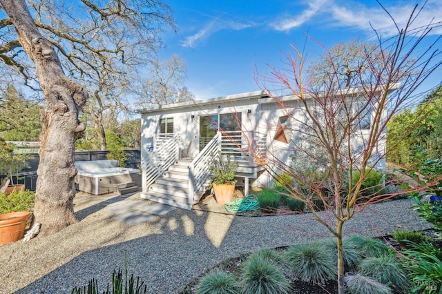 view of front of property with a hot tub