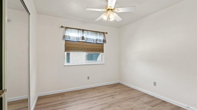 unfurnished room with light wood-type flooring, ceiling fan, and baseboards