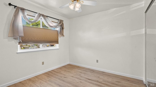 unfurnished room with ceiling fan, light wood-type flooring, and baseboards