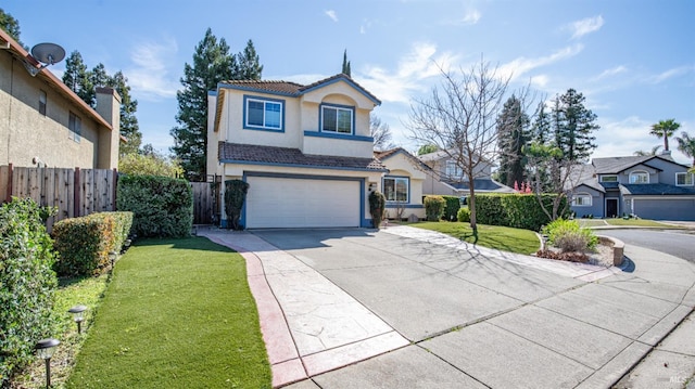 traditional-style house with a garage, a tile roof, fence, concrete driveway, and stucco siding