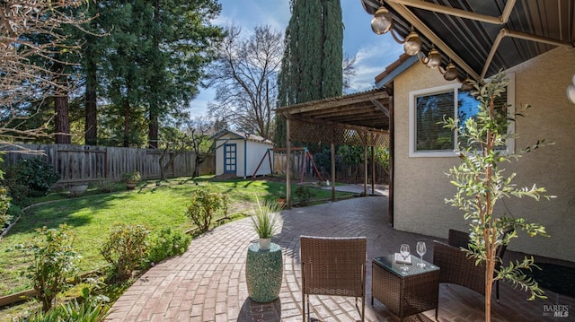 view of patio with a storage shed, an outdoor structure, and a fenced backyard