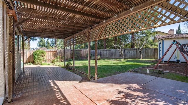 view of patio with an outbuilding, a fenced backyard, and a pergola