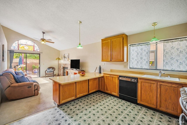 kitchen with black dishwasher, open floor plan, a peninsula, light countertops, and a sink