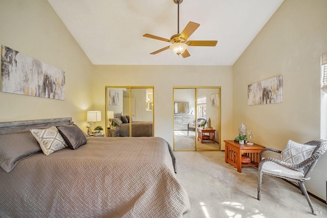 bedroom featuring a ceiling fan, carpet, high vaulted ceiling, and two closets