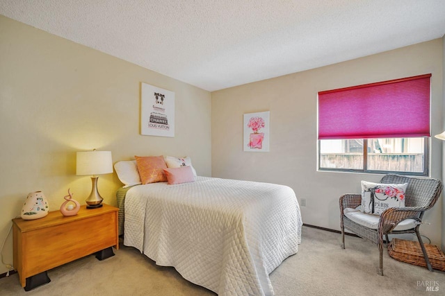 bedroom with a textured ceiling and carpet flooring