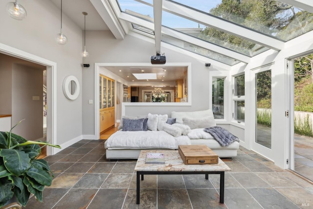 sunroom / solarium with vaulted ceiling with skylight