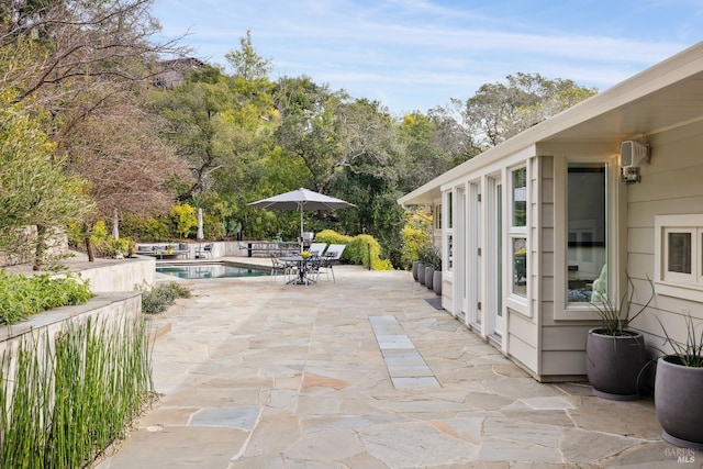 view of patio with outdoor dining space and a fenced in pool