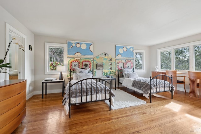 bedroom with wood finished floors and baseboards