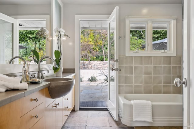 doorway to outside with a sink and stone tile flooring