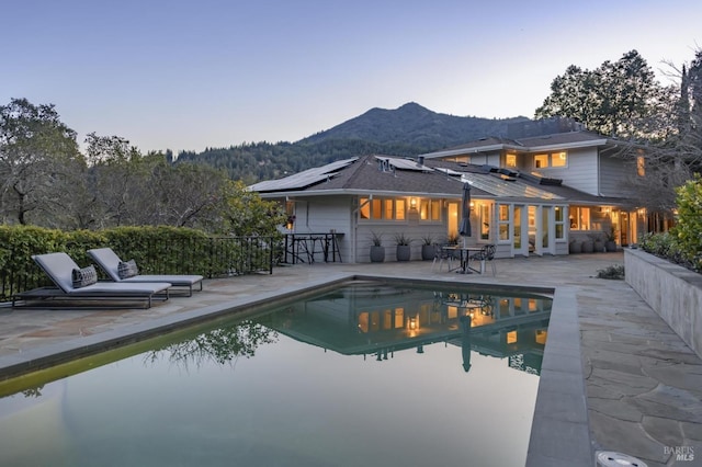 view of pool with a patio, a mountain view, and a fenced in pool