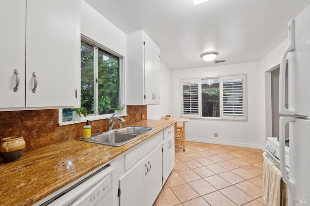 kitchen with tasteful backsplash, white appliances, white cabinets, and a sink